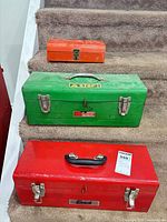 Front view of three metal tool chests stacked on stairs