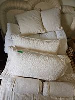 All pillows and comforter arranged on bed