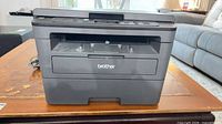Front view of Brother HL-L2390DW printer showing paper tray, output slot and control panel