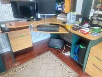 Full view of the L-shaped desk showing keyboard tray, drawers, cabinet and overall style