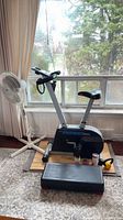 Stationary bike, fan, aerobic step, kettlebell, ankle weights group shot