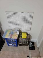 pegboard panel, blue crate with hardware cases, small-parts cabinet, box and tray