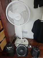 Full view of Lasko pedestal fan, Garrison heater, Chung Yuan desk fan, Intertek heater