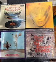 Four album covers laid out