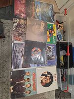 Top view of table showing multiple LPs: ELO, Lennon, Small Faces, Elvis, etc.