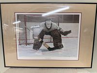 Front view of framed hockey goalie print with mat and frame visible