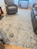 Full view of rug placed between seating, showing overall pattern and color