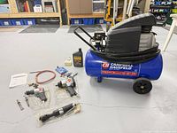 Compressor and all accessories laid out on floor