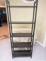 Front view showing five shelves and overall design