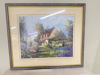 Front view of framed cottage landscape print showing artwork, mat and frame