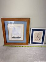 Both framed artworks side by side showing relative sizes and frames