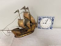 Front view showing metal ship sculpture and Schatz clock