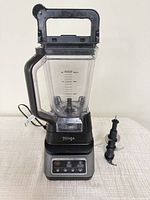 Front view of assembled Ninja blender with extra blade beside