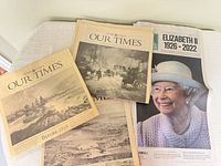 Four "Our Times" pictorial sections and Ottawa Citizen Elizabeth II tribute issue stacked on table