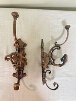 Both wall hooks front and side view showing design and size