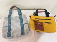 Front of gray Mona B tote and yellow nylon bag