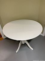 Full view of assembled round white dining table