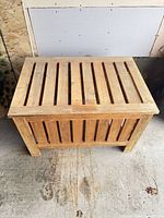 Front and side view of solid wood slatted storage bench