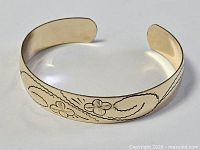 Full view of gold-filled cuff bracelet showing etched designs