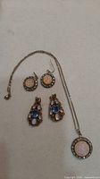 Lot overview showing necklace and both earring pairs