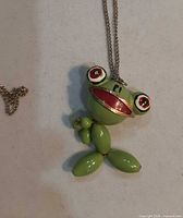 Front view showing frog pendant details and chain