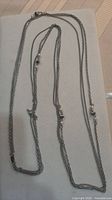 Full view of necklace laid out showing multiple strands and clasp