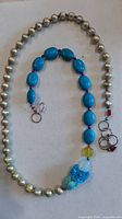 Full view showing entire necklace with pearl section, turquoise section and clasp