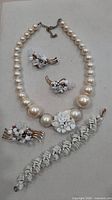 Entire parure laid out: necklace, earrings, brooch, bracelet