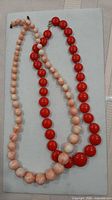 Both necklaces side by side showing colour and bead graduation
