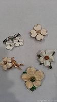 Group image of five vintage dogwood brooch pins