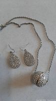 Full view of necklace and both earrings
