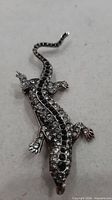Front view of rhinestone lizard brooch