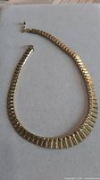 Full view of rolled gold necklace showing link design and clasp