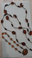 Both necklaces laid out showing bead types and pendant