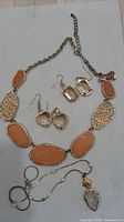 Full lot showing both necklaces and two earring pairs