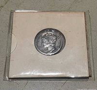 Coin in cardboard flip holder front view