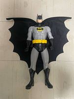 Front view of 12 in Batman figure with cape spread