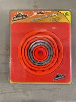 Front view of sealed Armor All collapsible traffic cone showing folded cone in blister pack