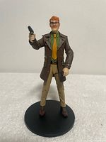 Front view showing full outfit, pistol, accessory, and stand