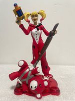 Front view of Harley Quinn figure showing costume, accessories and base