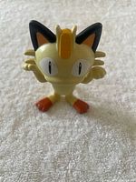 Front view of Meowth figure showing design and paint