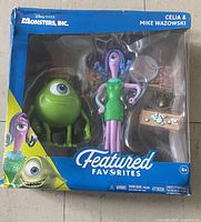 Front of sealed window box showing Mike Wazowski, Celia Mae figures and accessory
