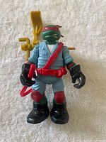 Front view of Raphael figure with accessories attached