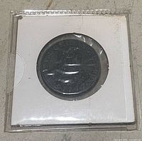 Coin in protective flip, overall view