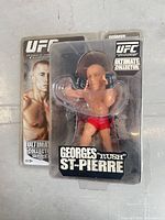 Front view of sealed Georges St-Pierre action figure in packaging