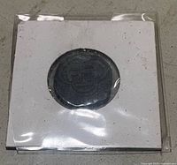 Front view of coin inside cardboard flip