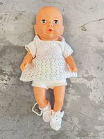 Front view of doll wearing knitted outfit