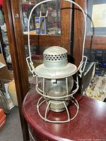 Full view of CNR metal railroad lantern on table