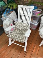 Front view of white slat-back rocking chair with cushions