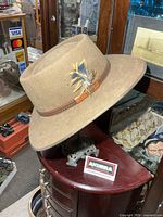 Front side view of light brown Akubra hat on display stand